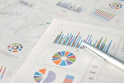 Charts and graphs with pen on table